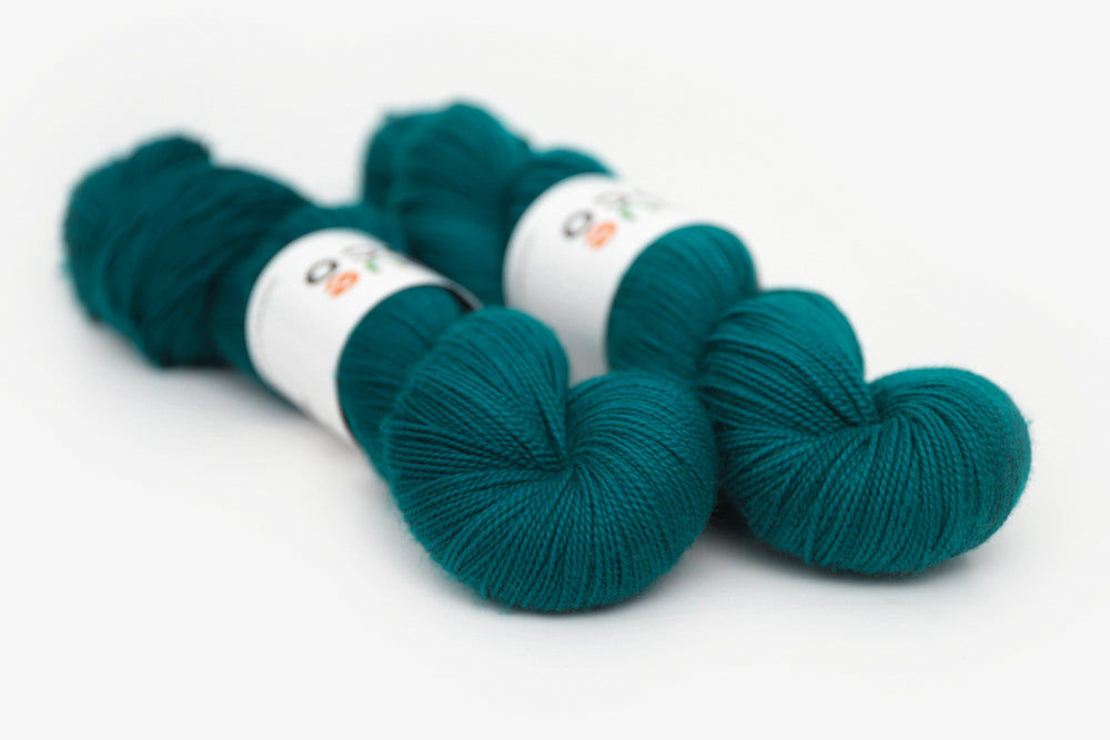 semisolid hand dyed blue green teal merino sock yarn 