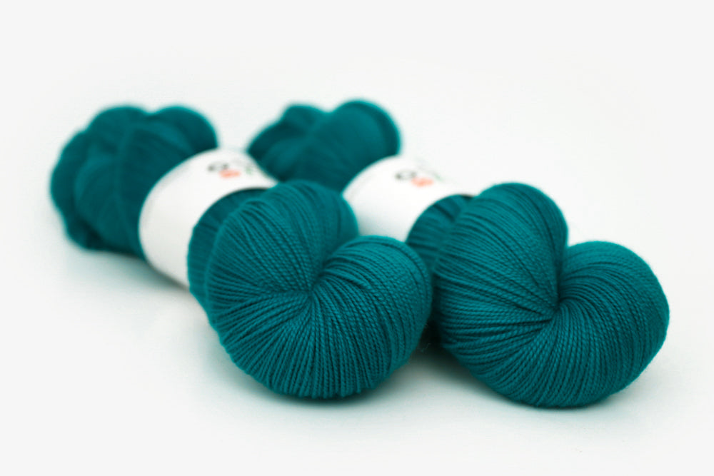 semisolid hand dyed blue green teal spun xl yarn