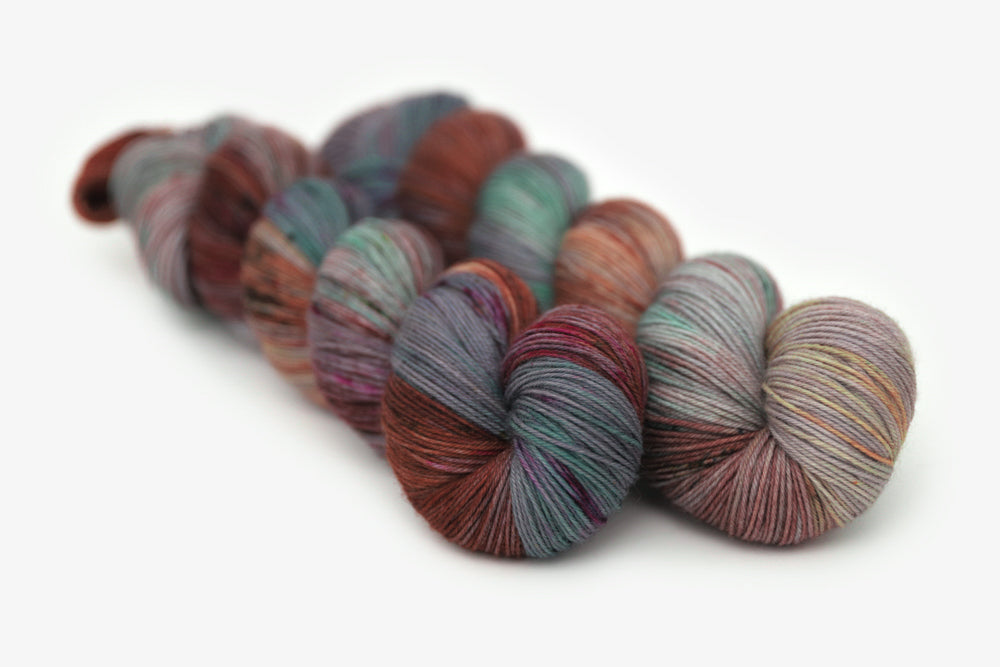 speckled hand dyed dark maroon gray teal orange phyllis sock yarn