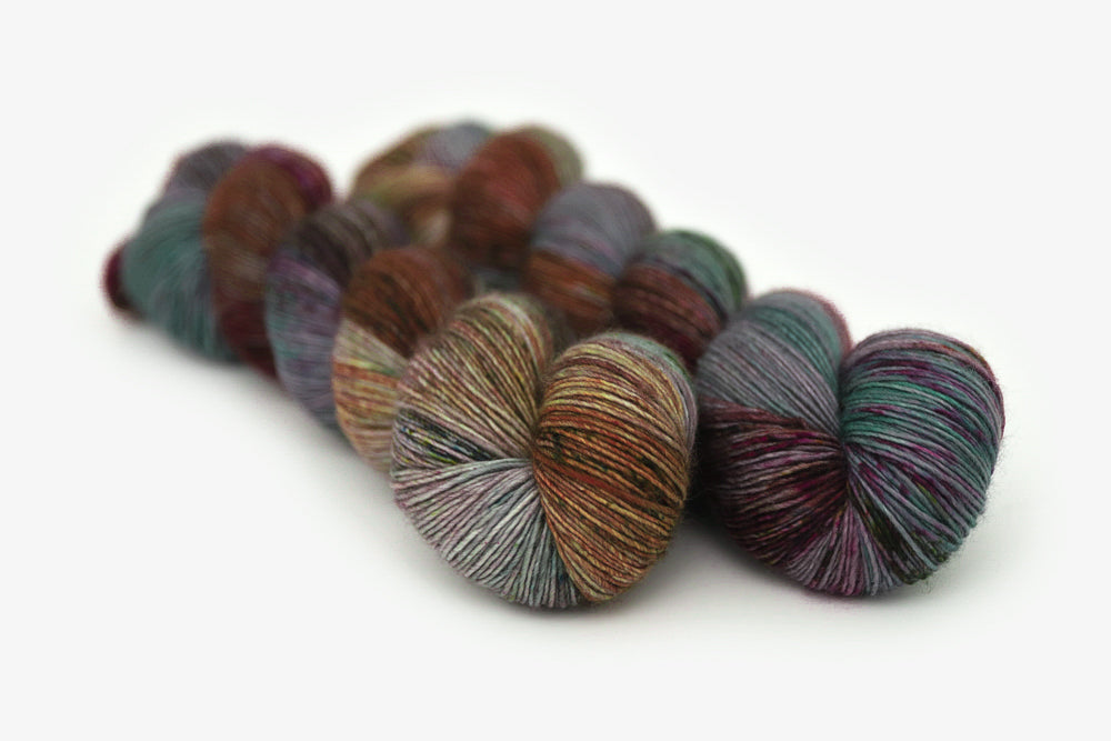 speckled hand dyed dark maroon gray teal orange single sock yarn