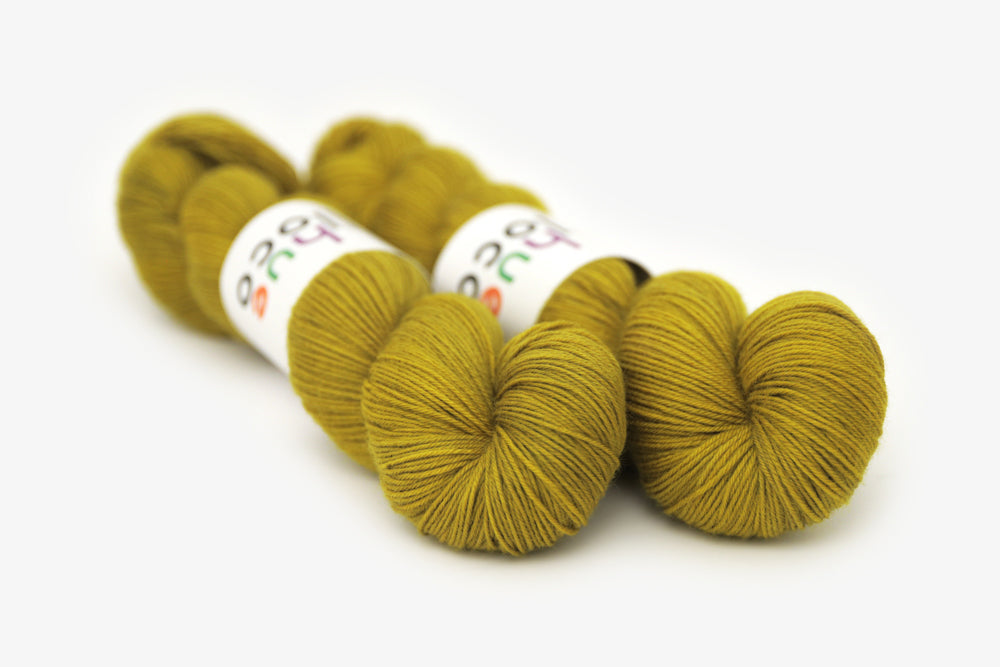 semisolid hand dyed caper (olive yellow green) phyllis sock yarn