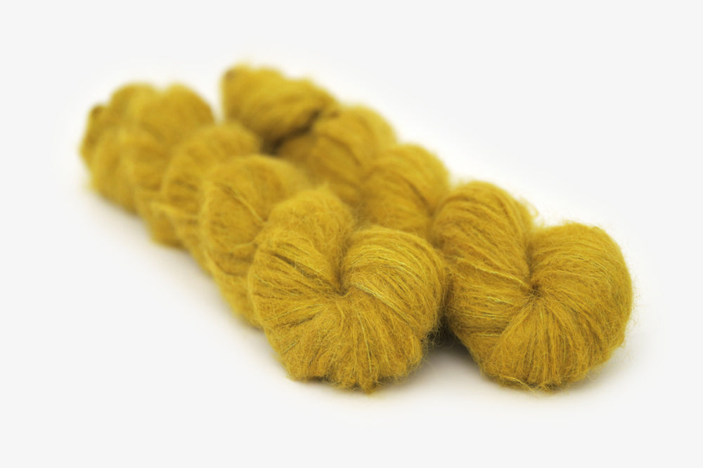 semisolid hand dyed caper (olive yellow green) alpaca suri lace yarn