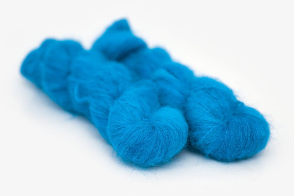 semisolid hand dyed cerulean (bright aqua blue) alpaca suri lace yarn