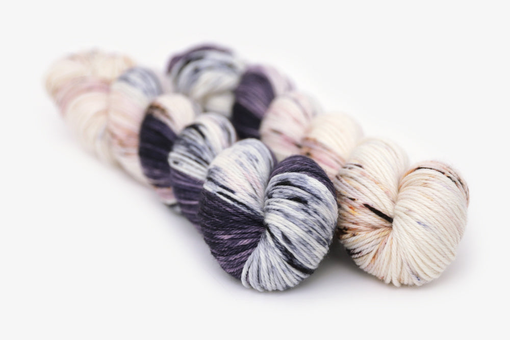 speckled hand dyed dark purple lilac white worsted yarn
