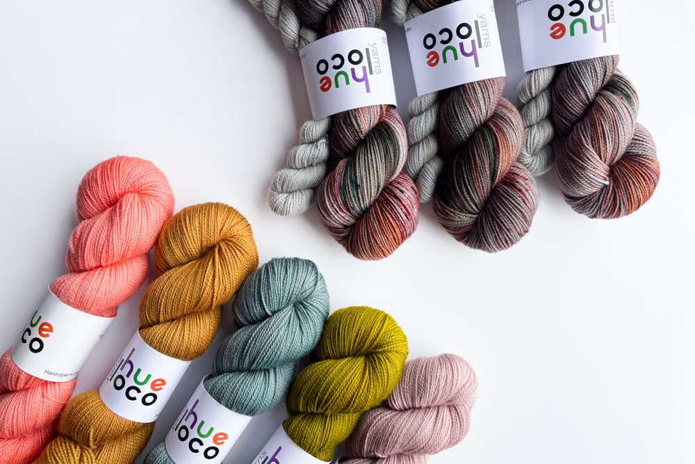 June sock set yarn with orange yellow teal green and purple coordinating yarn