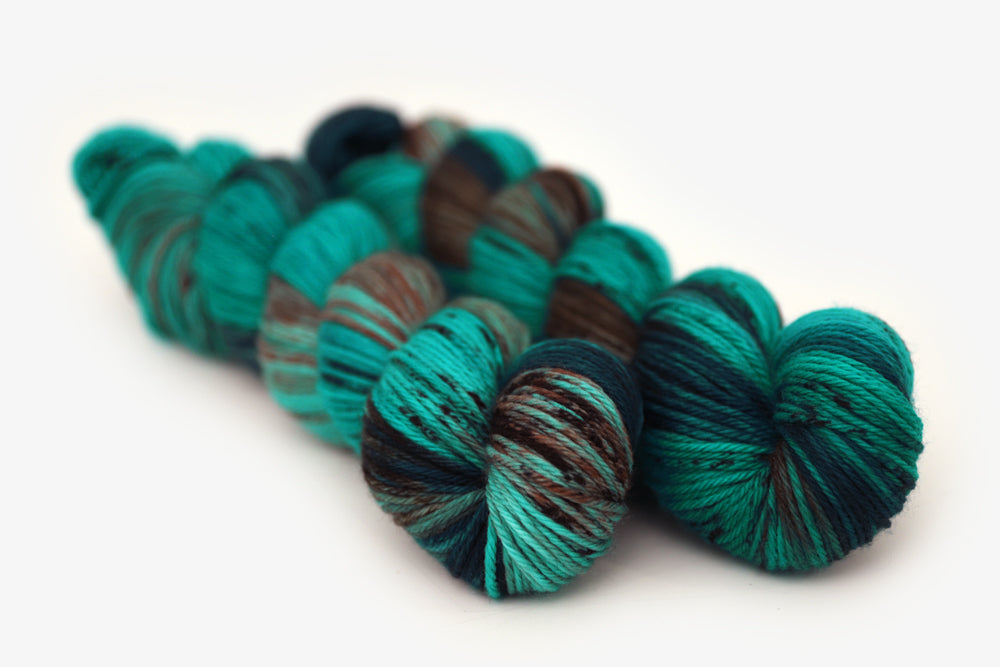 speckled hand dyed teal aqua dark purple worsted yarn