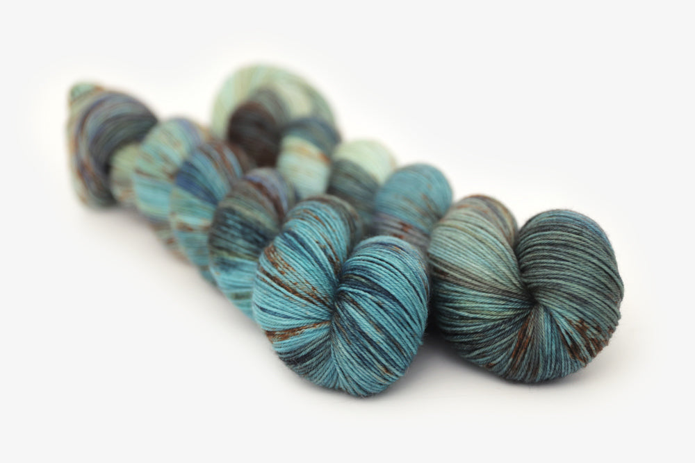 speckled hand dyed blue rust orange sage phyllis sock yarn