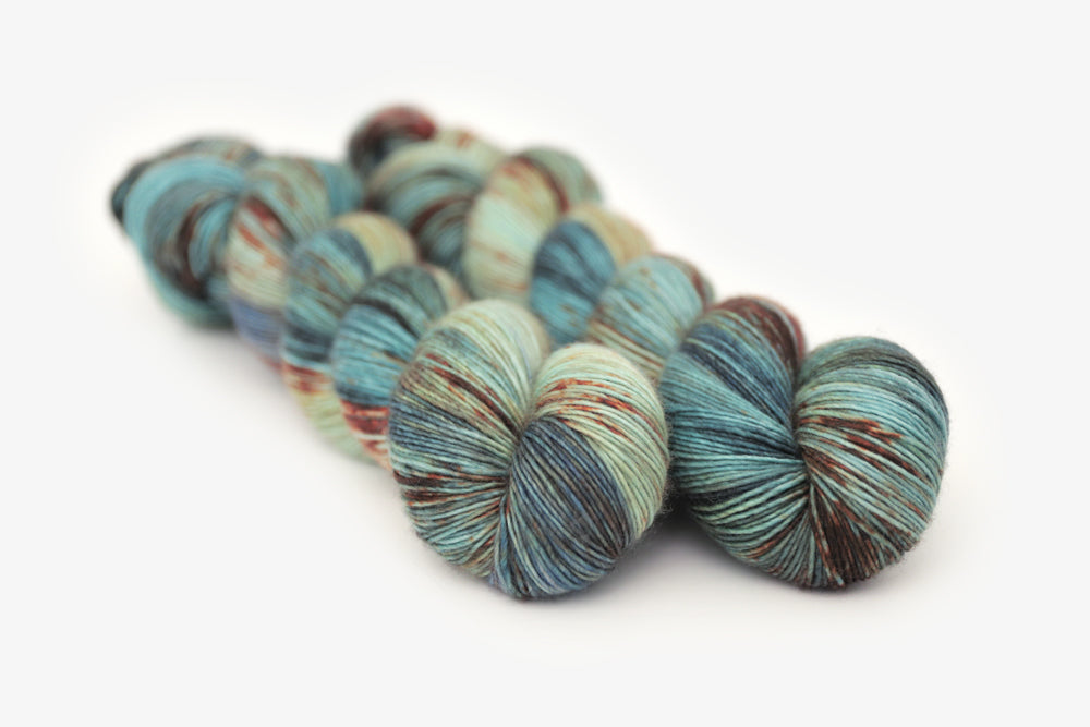 speckled hand dyed blue rust orange sage single sock yarn