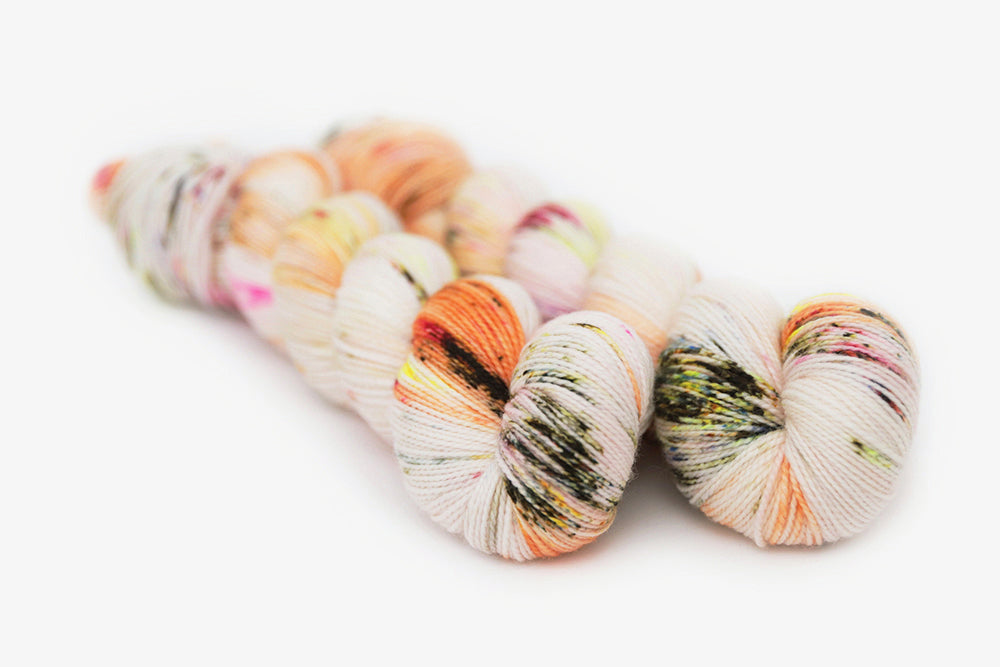 speckled hand dyed pink white neon yellow orange merino sock yarn