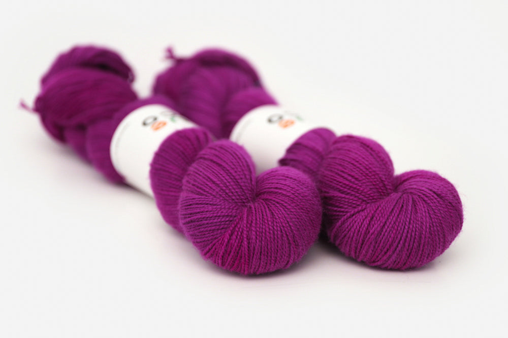 semisolid hand dyed mulberry (magenta berry pink) merino sock yarn