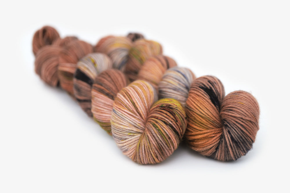 speckled hand dyed dusty pink yellow blue tan dk yarn