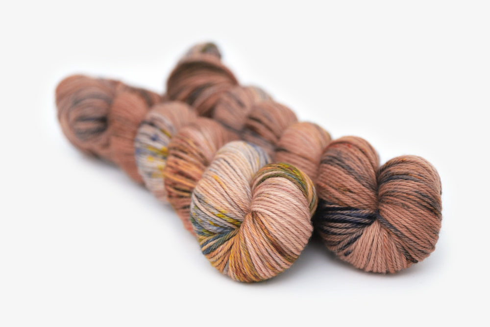 speckled hand dyed dusty pink yellow blue tan worsted yarn