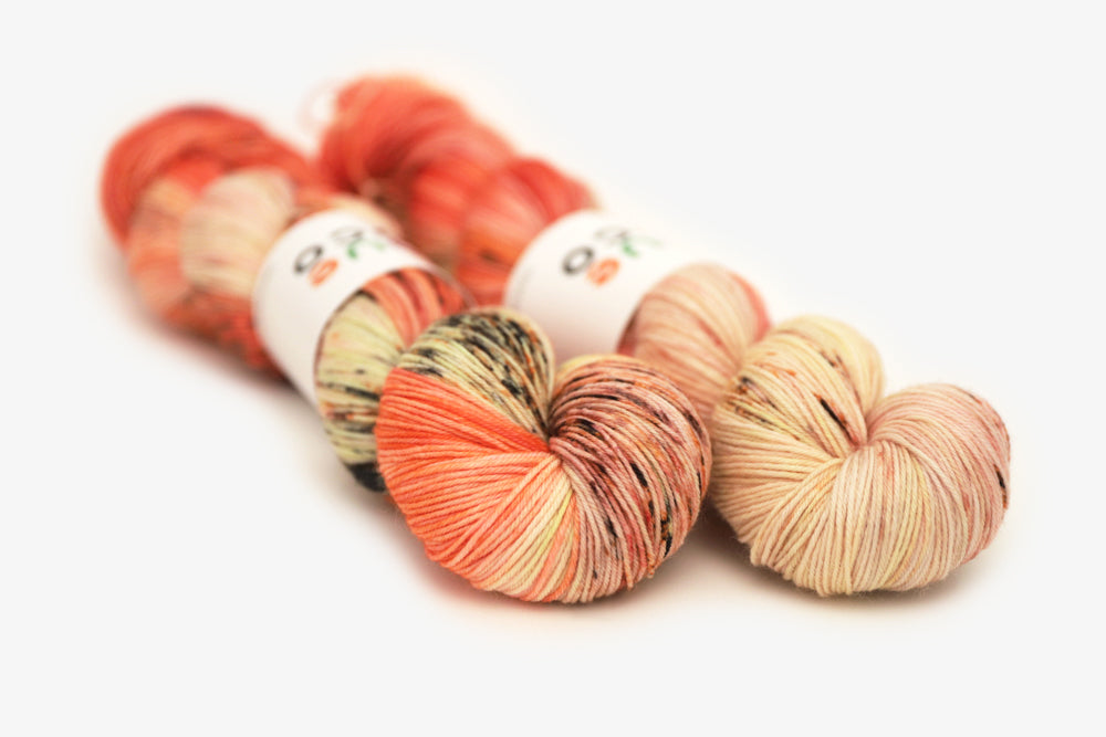 speckled hand dyed bright orange coral pink phyllis sock yarn