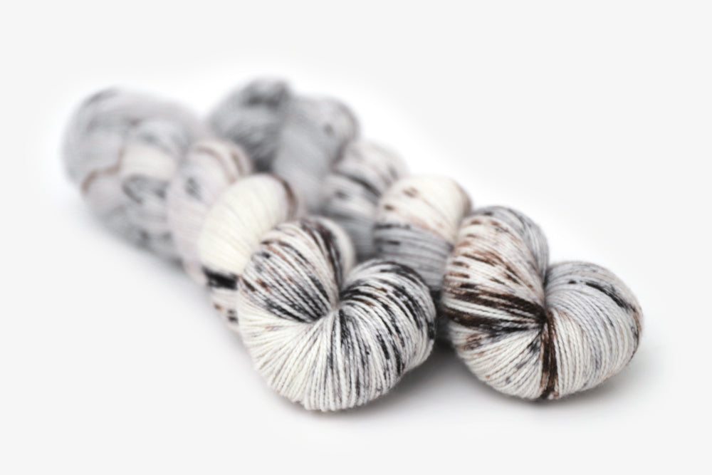 speckled hand dyed cool white gray brown merino sock yarn