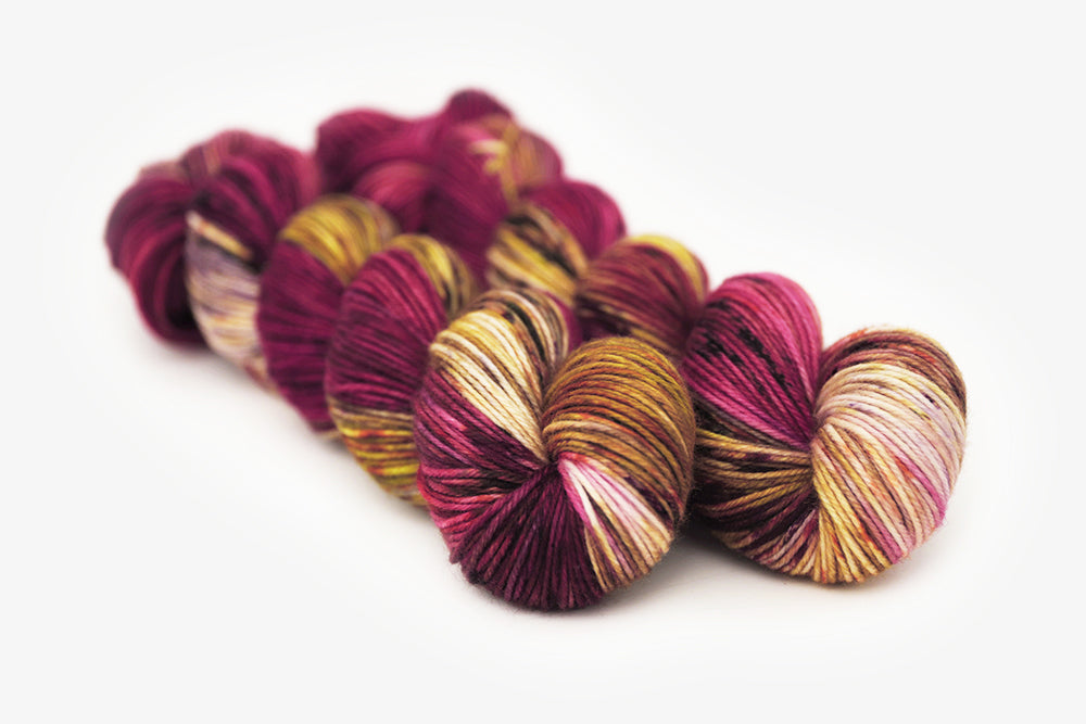 speckled hand dyed magenta gold olive dk yarn