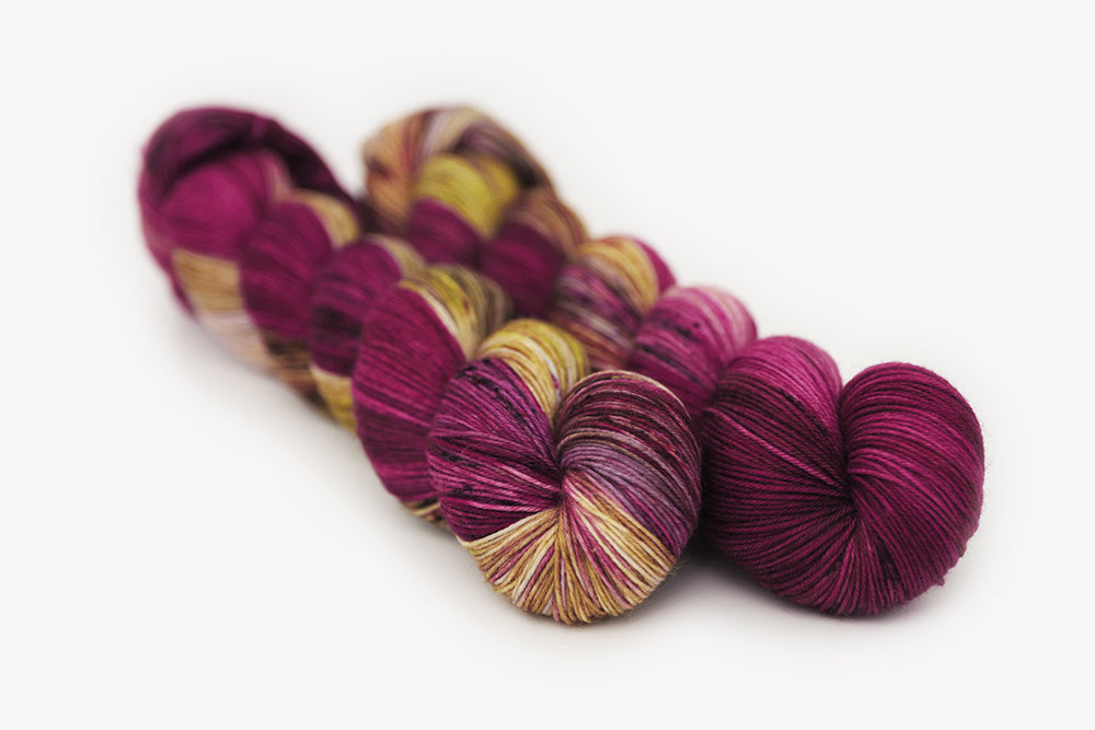 speckled hand dyed magenta gold olive phyllis sock yarn