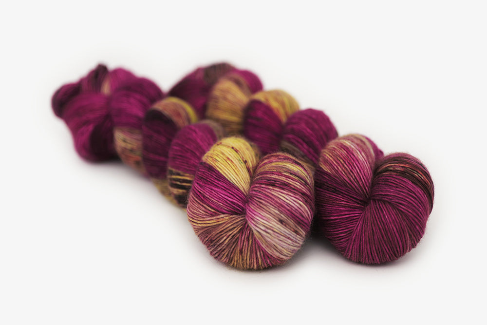 speckled hand dyed magenta gold olive single sock yarn