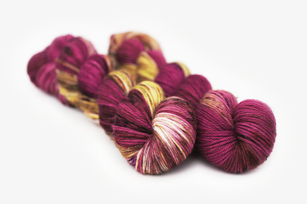 speckled hand dyed magenta gold olive worsted yarn