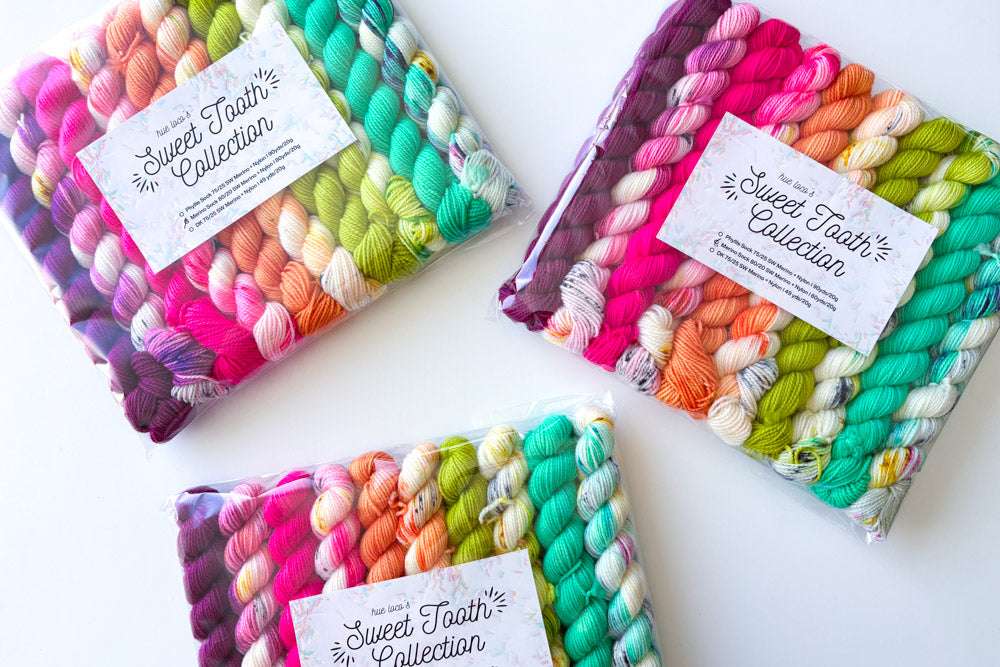speckled semisolid hand dyed purple fuchsia orange white green cyan yarn set
