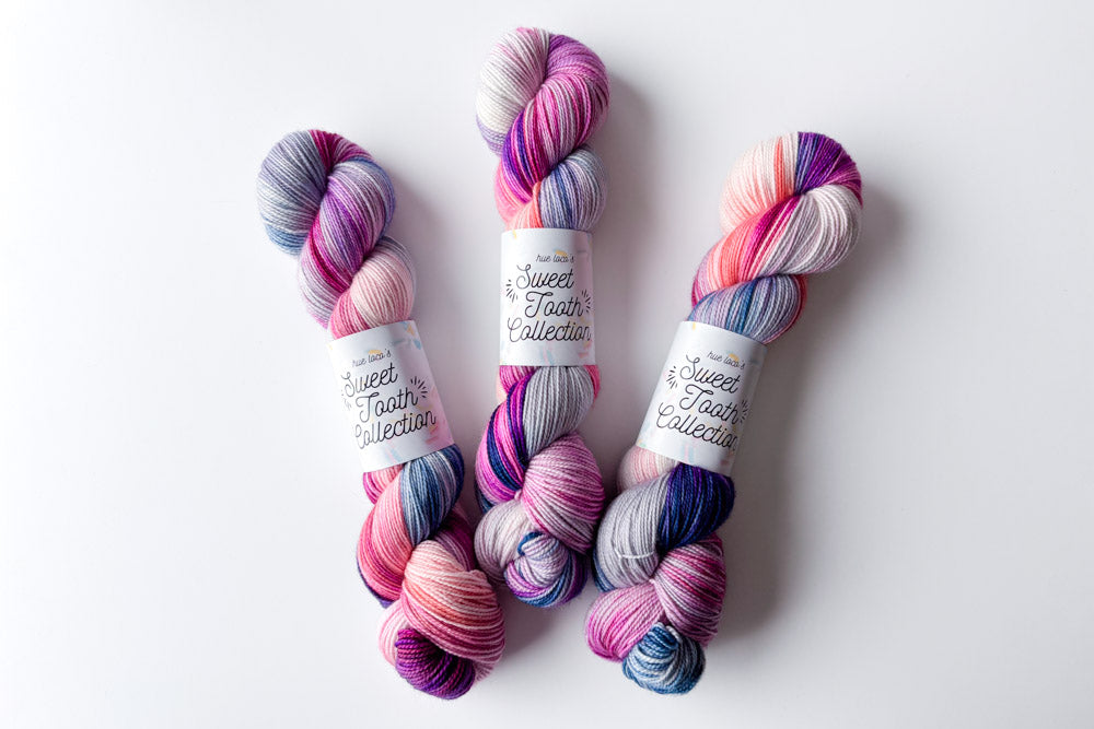 tonal hand dyed white fuchsia bright purple light blue pink yarn