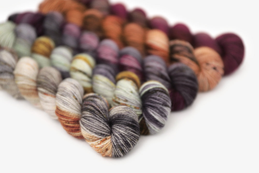 speckled hand dyed orange red gray green yarn 50s set