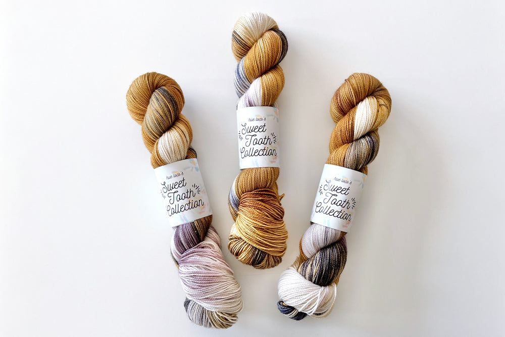 tonal hand dyed white tan purple brown blue yarn