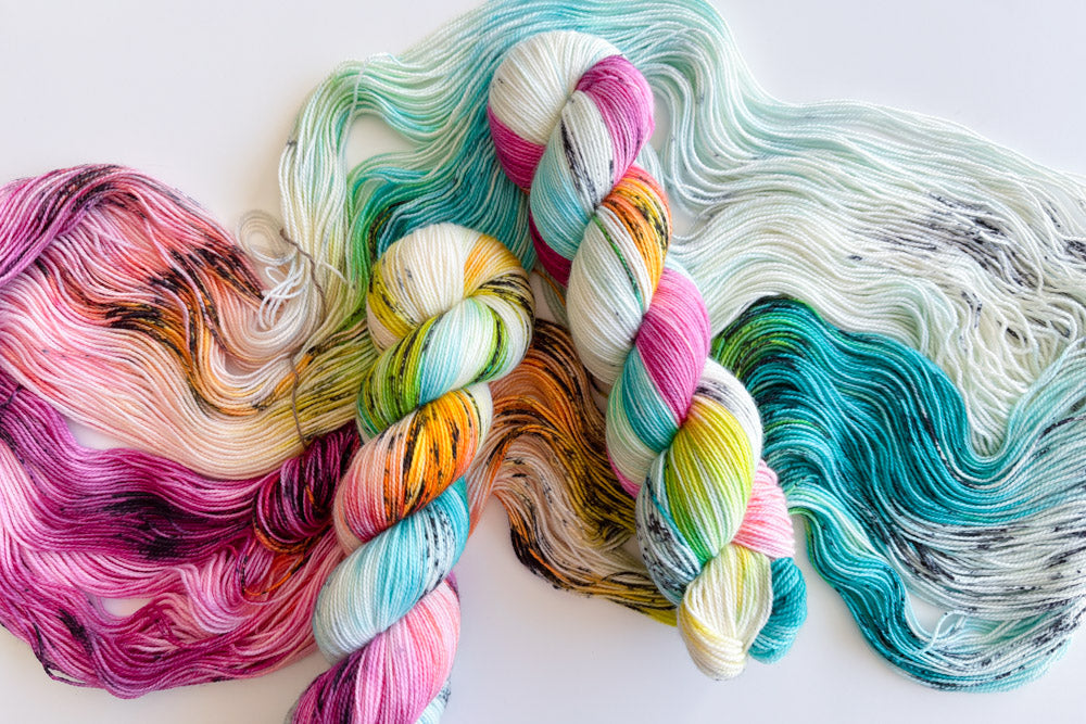 speckled hand dyed white magenta turquoise blue orange green yarn