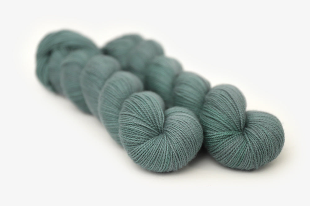 semisolid hand dyed sage green merino sock yarn