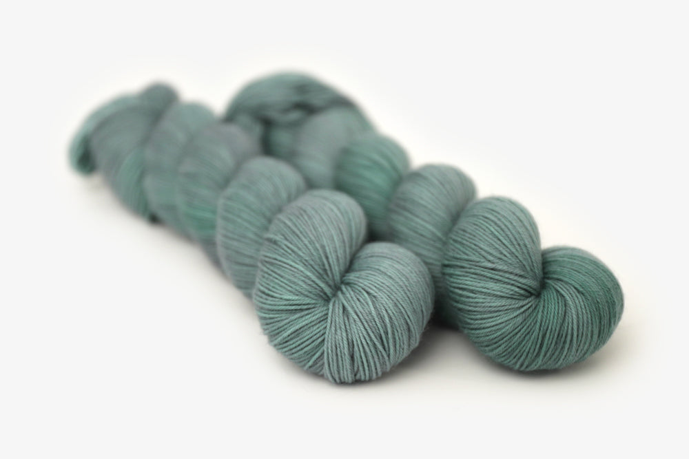 semisolid hand dyed sage green phyllis sock yarn