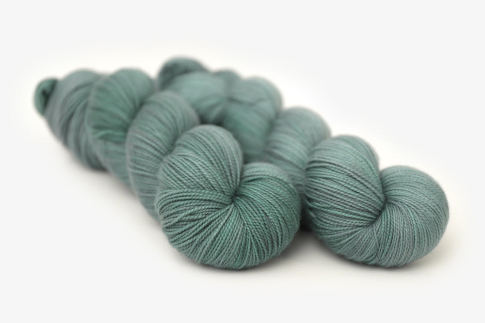 semisolid hand dyed sage green spun sock xl yarn