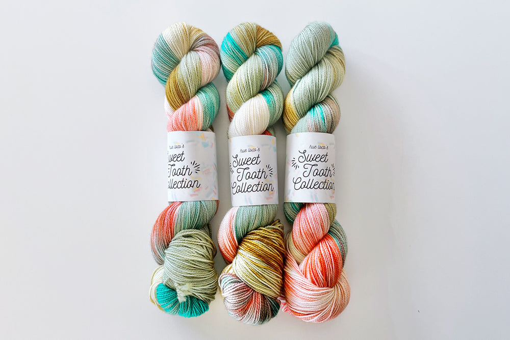 tonal hand dyed pale pink white tan teal aqua red yarn
