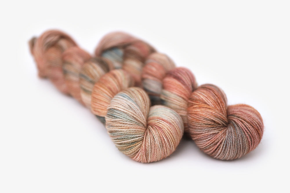 tonal peach blush ochre teal merino sock yarn