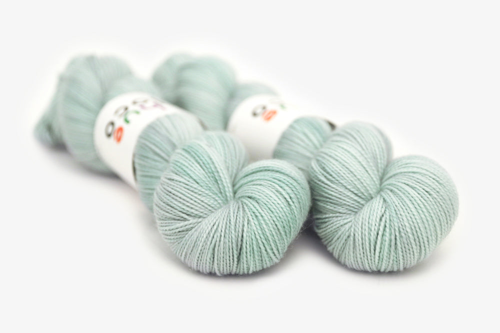 semisolid hand dyed light powder blue merino sock yarn