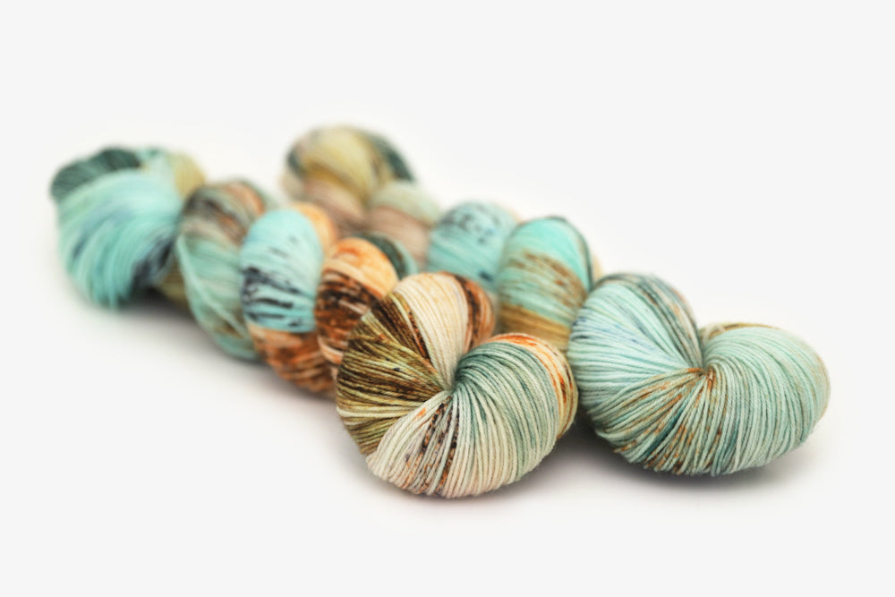 speckled hand dyed bright teal emerald tan orange phyllis sock yarn