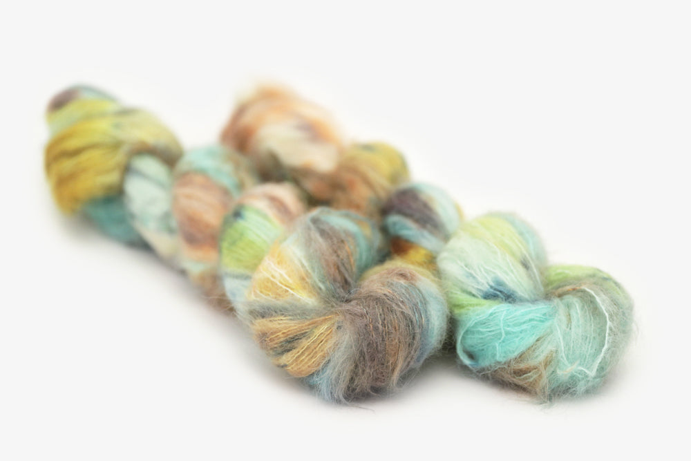 speckled hand dyed bright teal emerald tan orange alpaca suri lace yarn