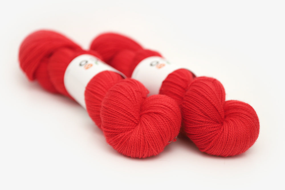 semisolid hand dyed cherry (bright christmas red) merino sock yarn