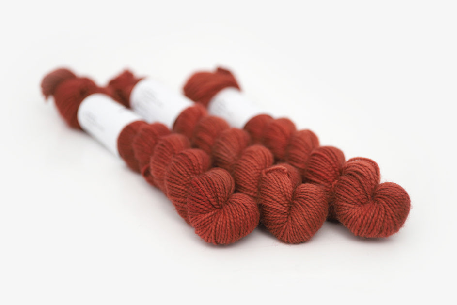 semisolid hand dyed dark rust red merino sock mini yarn
