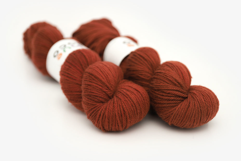 semisolid hand dyed dark rust red worsted yarn