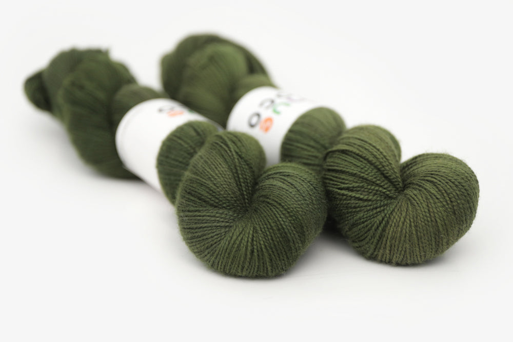 semisolid hand dyed dark forest green merino sock yarn