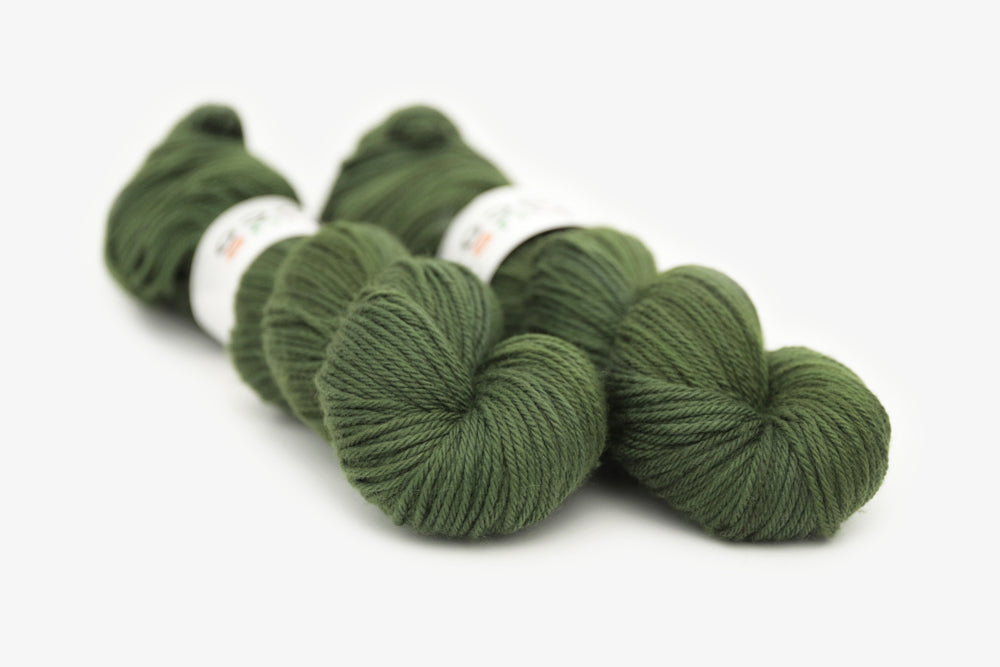 semisolid hand dyed dark forest green worsted yarn