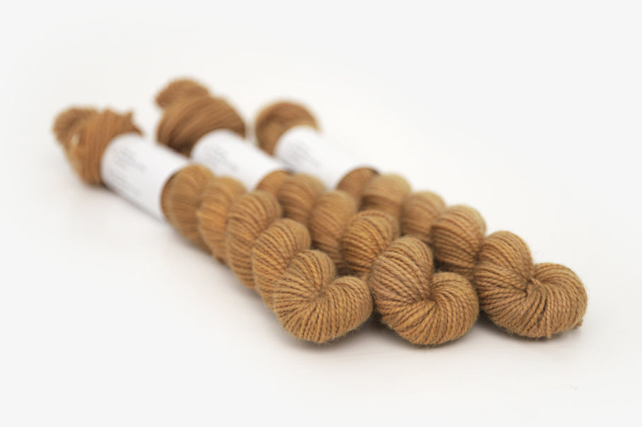 semisolid hand dyed ochre (dark bronze yellow) merino sock mini yarn