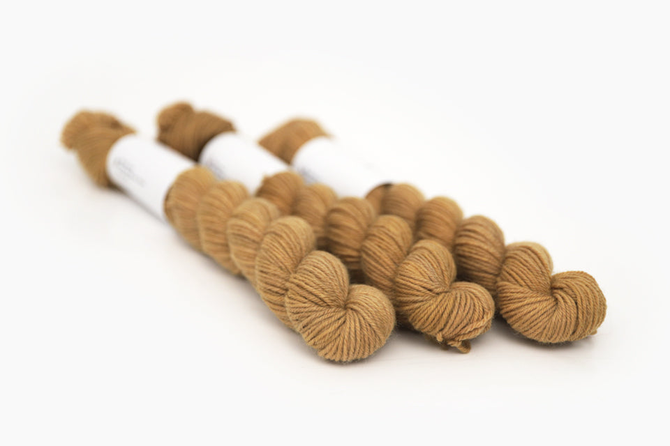 semisolid hand dyed ochre (dark bronze yellow) phyllis sock mini yarn