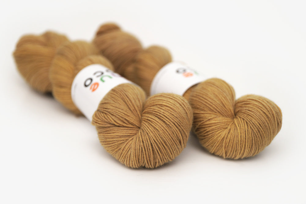 semisolid hand dyed ochre (dark bronze yellow) phyllis sock yarn