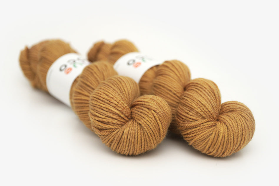 semisolid hand dyed ochre (dark bronze yellow) worsted yarn