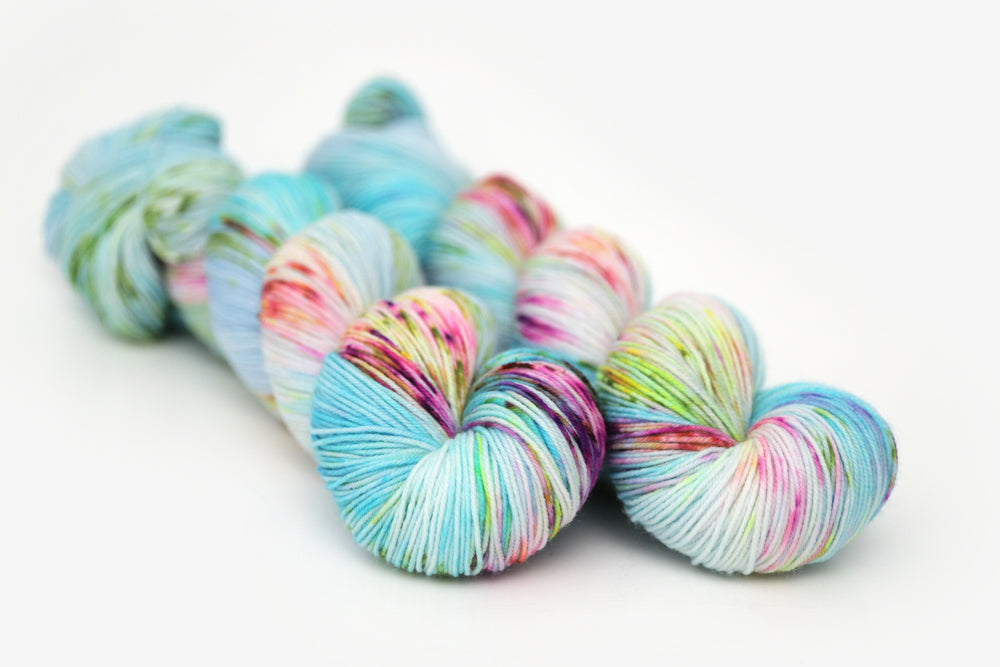 speckled hand dyed bright aqua green purple phyllis sock yarn