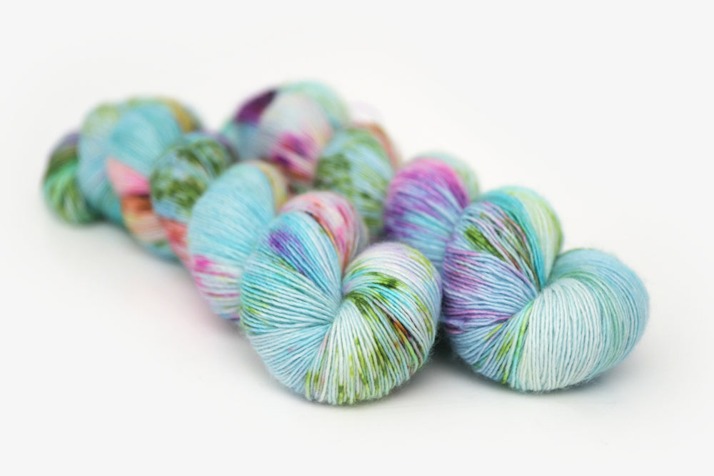 speckled hand dyed bright aqua green purple single sock yarn