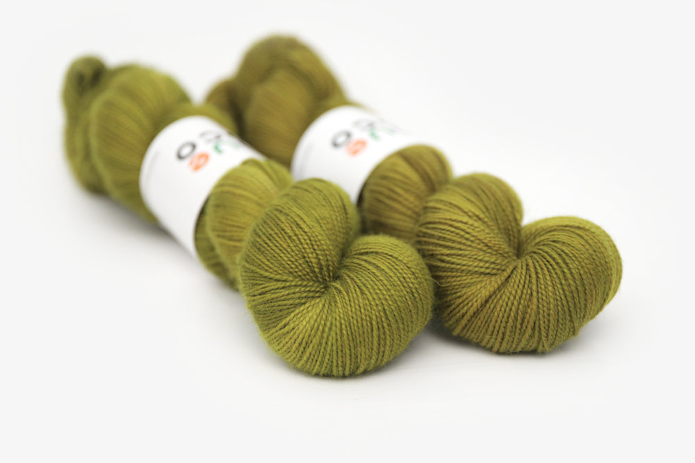 semisolid hand dyed pear (dark olive yellow green) merino sock yarn