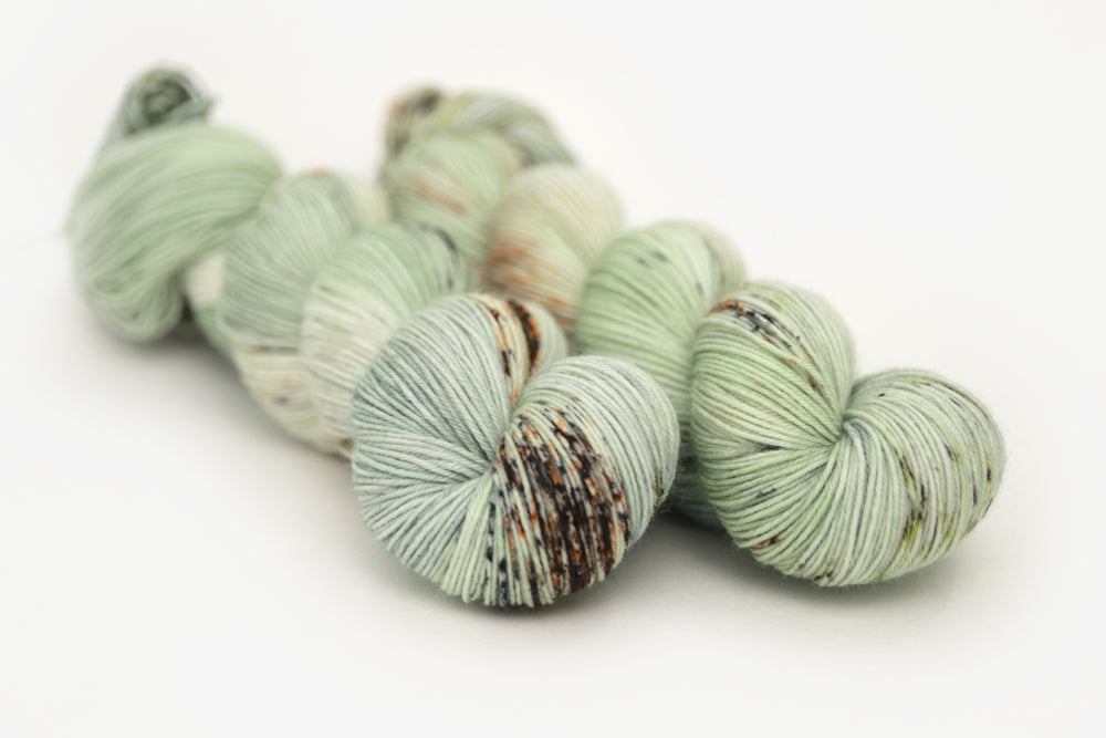 speckled hand dyed pale green sage peach phyllis sock yarn