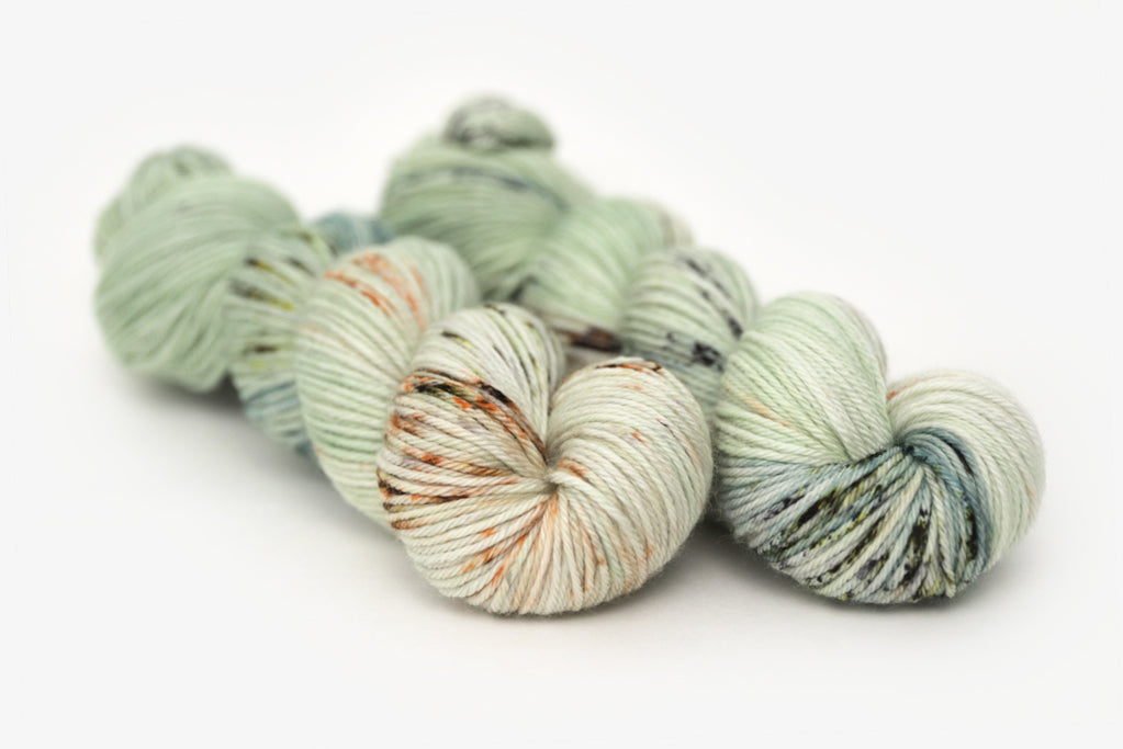 speckled hand dyed pale green sage peach worsted yarn
