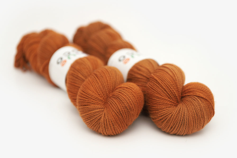 semisolid hand dyed pumpkin (dark burnt orange) merino sock yarn